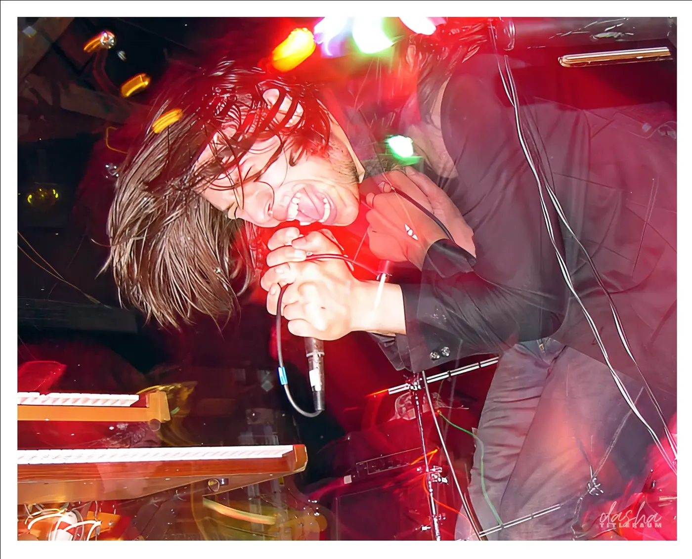 Action Action, Keyboard and vocal moment captured under saturated stage color.