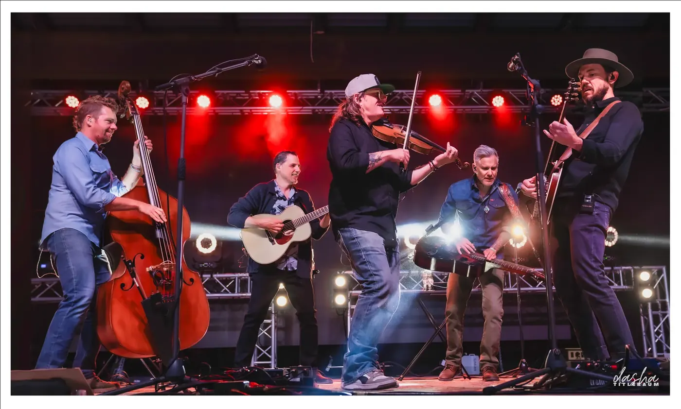 The Infamous Stringdusters, Bluegrass ensemble mid-song, capturing acoustic performance detail.